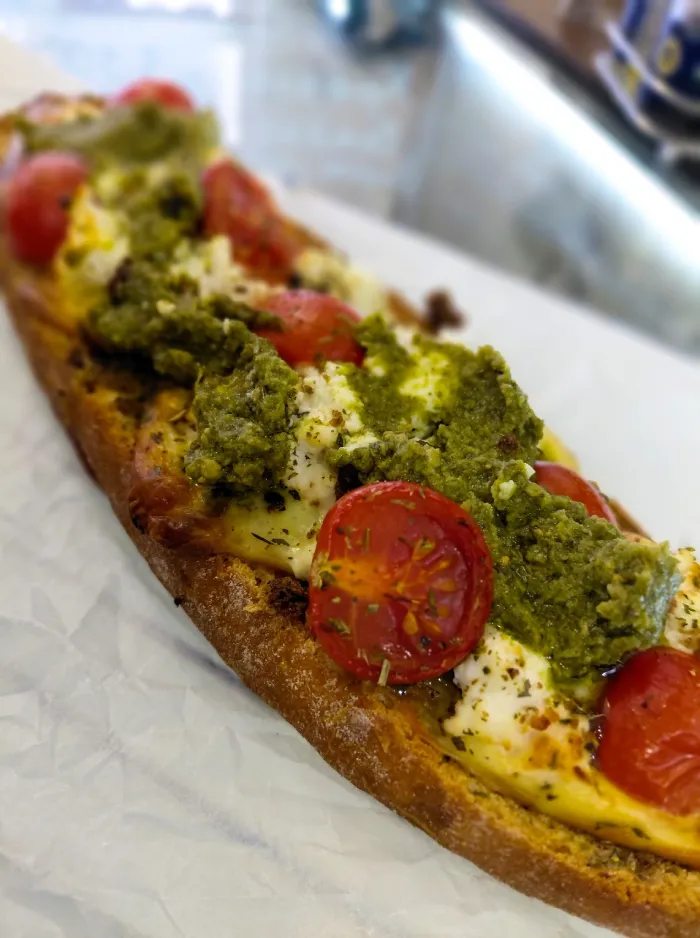 Toasted sandwich with mozzarella, cherry tomatoes and pesto